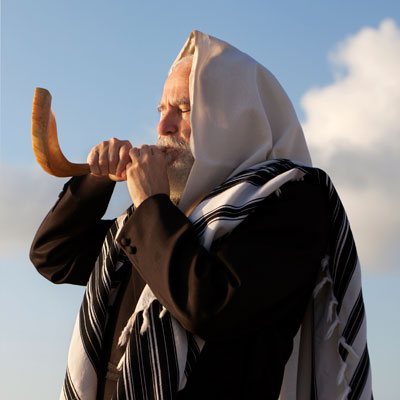 Jewish man blowing shofar